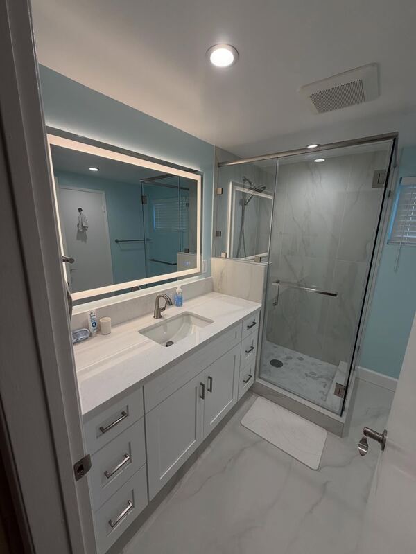 Remodeled bathroom in Arcadia, with a white vanity and a glass shower