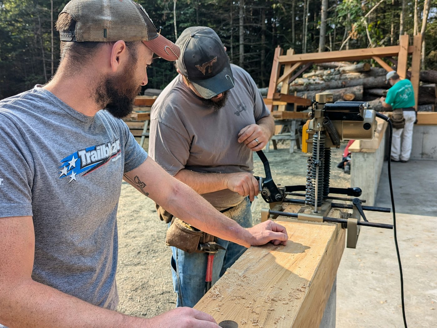 Two Lee & Company Construction carpenters working a timber together on site